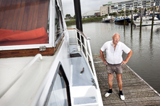2012-16 Man bij boot in jachthaven. Op de achtergrond de Van Brienenoordbrug. De foto is gemaakt in opdracht van De ...
