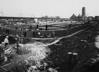 IV-338-58 Bouw van de nieuwe kademuur langs de Delftsevaart. Op de achtergrond het spoorwegviaduct en de Sint-Laurenskerk.