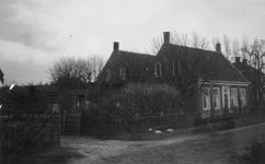 1976-2279 In de omgeving van Dordrecht een landweg met huizen.