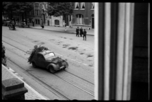 1980-5478 Dolle Dinsdag. Vertrekkende Duitse militairen in een met takken gecamoufleerde auto in de Van ...