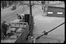 1980-5824 Werkzaamheden vanuit een vrachtwagen in de Scheepstimmermanslaan nabij de Zalmhaven. Een man sorteert jute ...