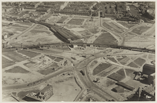 III-251-04-8 Luchtfoto van het Hofplein met het spoorwegstation en het spoorviaduct en omgeving, in een verder lege ...
