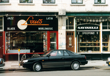 1992-4282 Winkels in de Nieuwe Binnenweg. Afgebeeld van boven naar beneden:-4282: muiziekwinkel Louis en Savinelli ...
