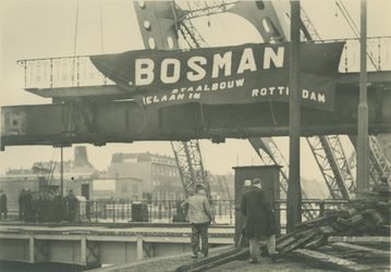 X-234-00-01-02-4 De vernieuwing van de Ruigeplaatbrug bij Schiemond. Plaatsing van de brugdek met reclame van de Bosman ...
