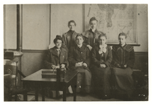 1975-384 Een groepsfoto van onderwijzeressen in een klas met of tafel een collectebus.