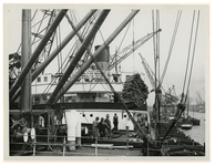 1976-14495 Verladen van houten balken op schepen.