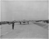 182-10 Vliegtuig wordt door marshaller op het nieuwe vliegveld Zestienhoven naar zijn plek geleid.