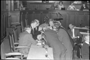 22204-7 Overleg bij de bestuurstafel met voorzitter W.A. Fibbe tijdens vergadering Rijnmondraad in raadszaal stadhuis ...