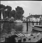 6628 Woonbootje in de Veerhaven; op de achtergrond het houten botenhuis en stenen gebouw van de sociëteit Koninklijke ...