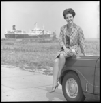 6761 'Hilton Miss Washington' zit op de motorkap van een Triumpf-automobiel; op de achtergrond een olietanker.