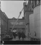 85-1 Brandweerlieden in actie met ladderwagen tijdens een alarmoefening van de Rotterdamse brandweer .