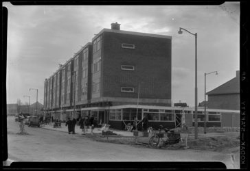 THO-48 Nieuwgebouwd woonblok met winkels op de begane grond aan de Burgemeester Baumannlaan. Rechts wordt de 2e ...