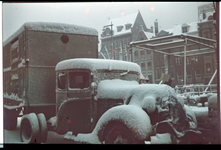 65 Vrachtwagen in de sneeuw op de Wijnhaven. Op de achtergrond de Grote Wijnbrug