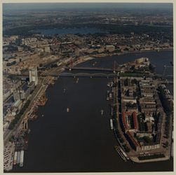 1988-721 Luchtopname van de Nieuwe Maas bij het Noordereiland, met verderop de spoorbrug en de Nieuwe Willemsbrug, en ...