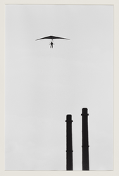 4 Deltavlieger hangt in de lucht vlakbij de schoorstenen van een energiecentrale. Uit eens serie van 8 foto's over ...
