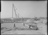 L-2682 Bouwvakkers plaatsen staaldraden bij de bouw van de Blijdorpsebrug bij de Kanaalweg. Op de achtergrond een heimachine.