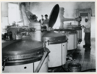 1977-3046 Koks van de centrale keuken bereiden voedsel in grote ketels. De gaarkeukens werden gebouwd om de ...