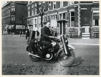 1977-3458 Een motorrijder rijdt op motorfiets met houtgasgenerator, vanwege de schaarste in fossiele brandstoffen ...