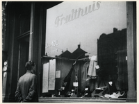 1977-3494 Een ruilwinkel aan de Oostzeedijk-Beneden tijdens de bezettingsjaren in de Tweede Wereldoorlog. In de etalage ...