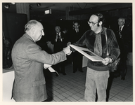 1978-2728 Directielid van de Bijenkorf overhandigt wethouder Riezenkamp (rechts) een foto.